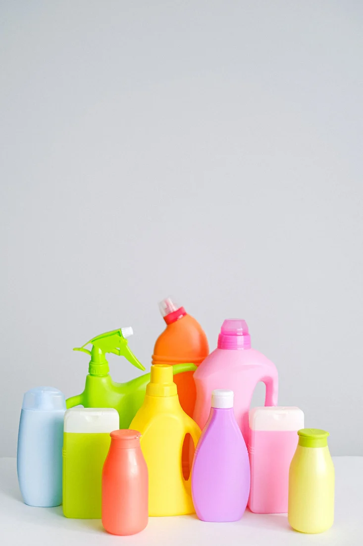 Assorted plastic cleaning containers with spray and dispensing closures